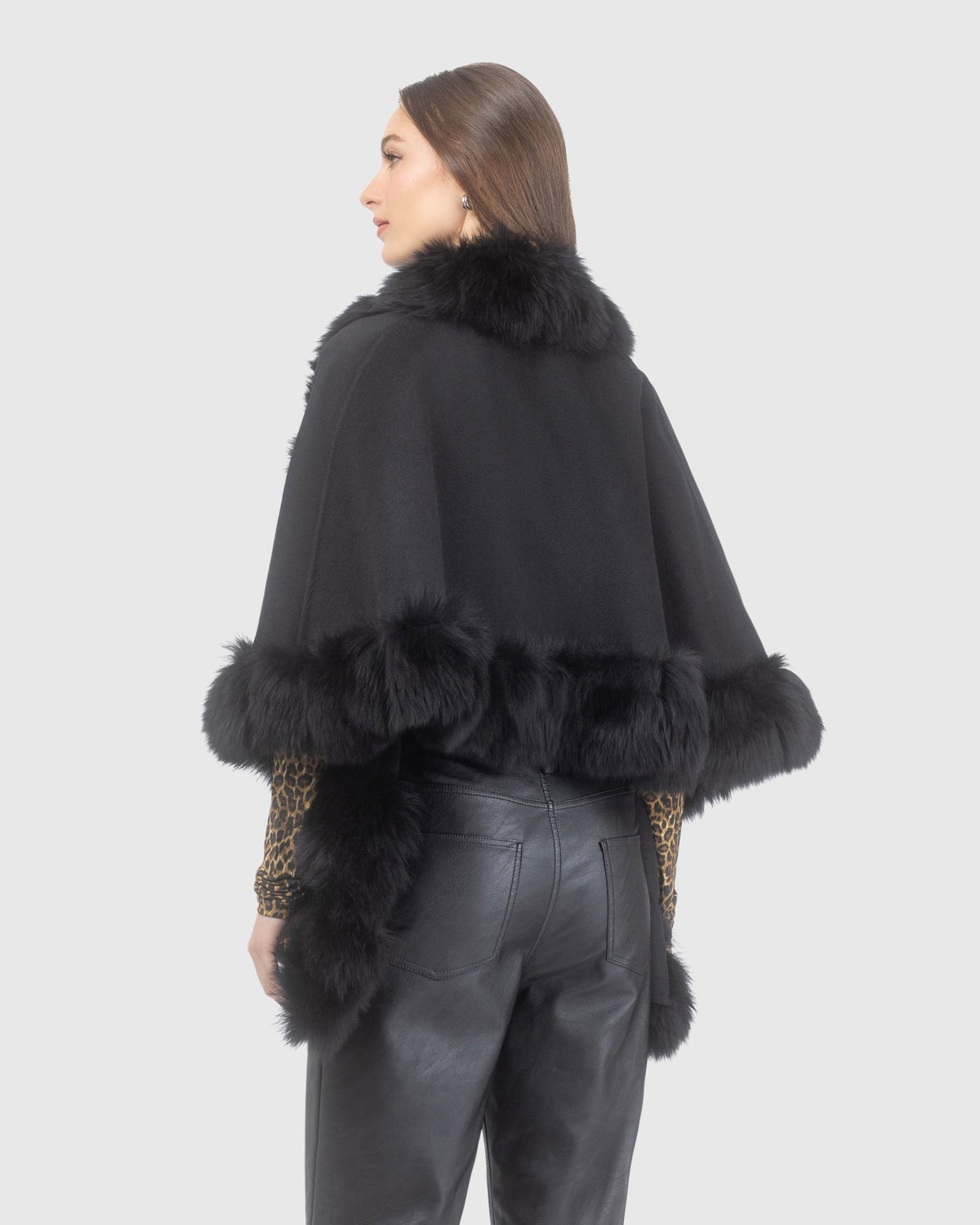 Reversible cashmere and wool shawl crafted from Loro Piana with merinillo shearling lamb trim in black, back view